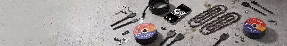 Automotive tools and parts arranged on a concrete surface with coiled cables, sockets, wrenches and red labeled reels