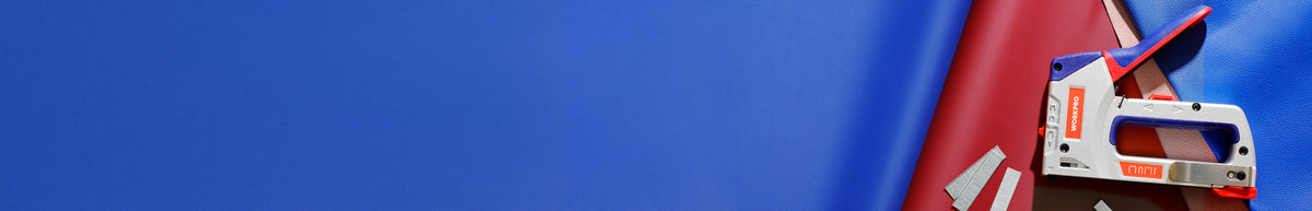 Red and blue fabric surface with a small white and red handheld device featuring a display and attached blue cord
