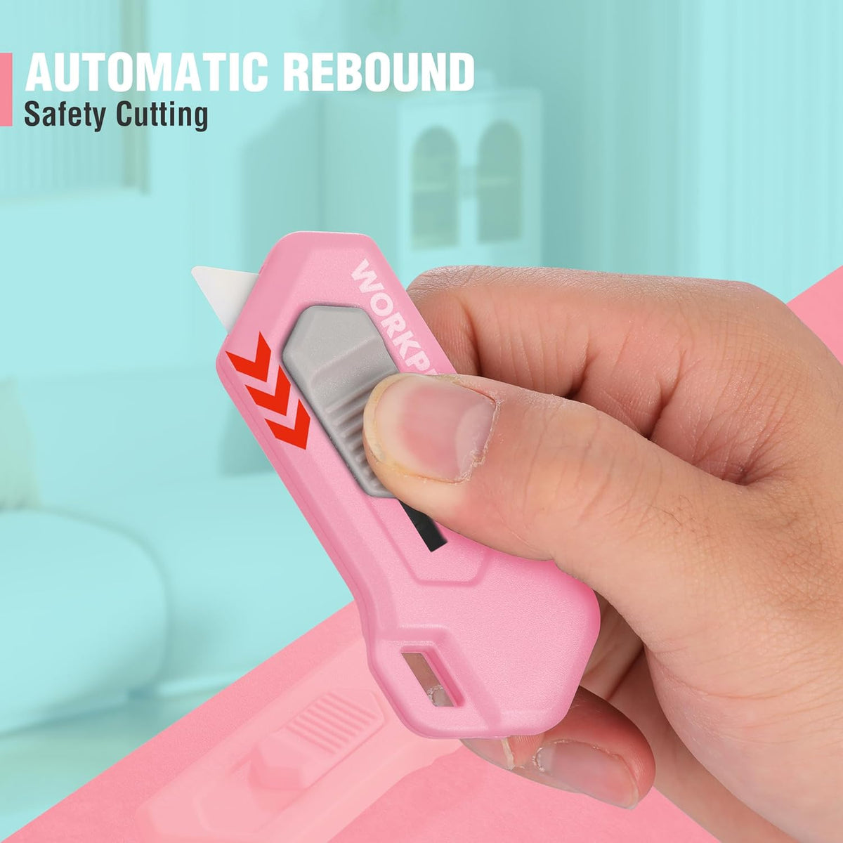 Pink automatic rebound safety box cutter held in hand with blade extended