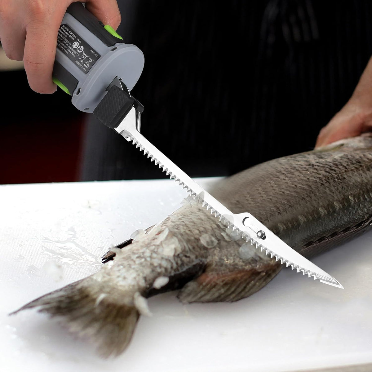 Replacement fillet blade attached to an electric knife, cutting fish