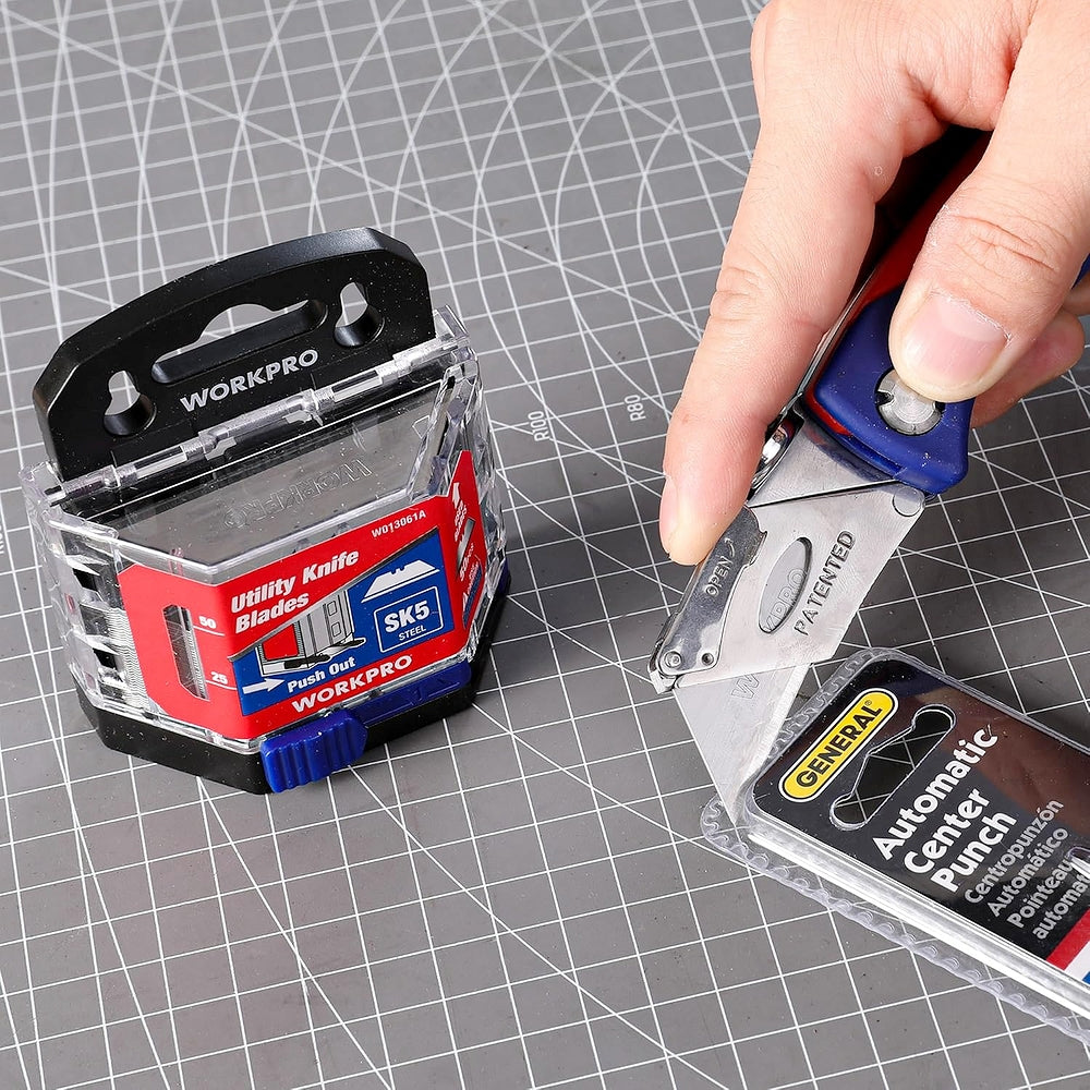 Utility knife blade pack beside utility cutter with replacement blade on mat