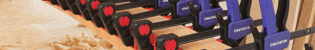 Rows of black and purple dumbbells with red weight markings on a textured gym floor