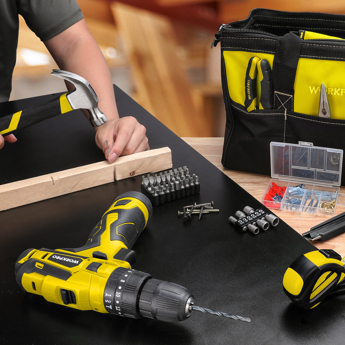 Cordless drill/driver holding a drill bit with screwdriving bits and fasteners