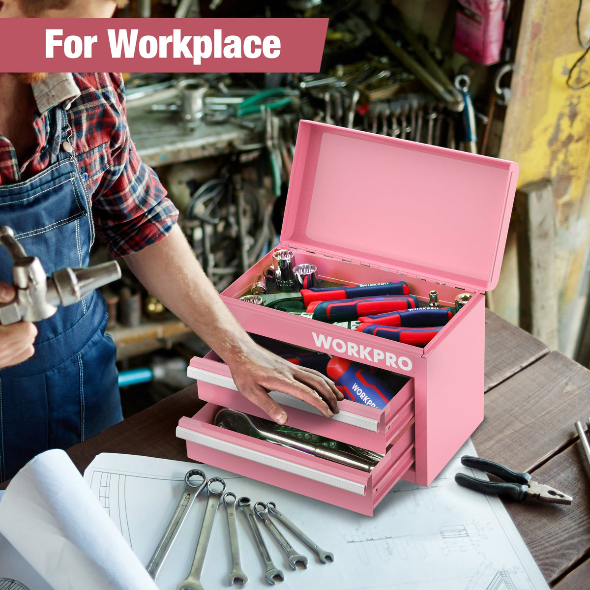 Pink mini tool chest on workbench, open drawers filled with tools.