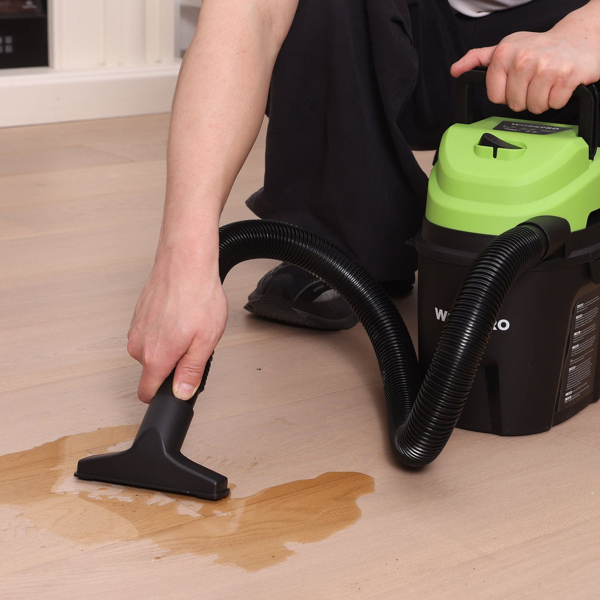 Portable wet/dry shop vacuum cleaner with floor nozzle and dual black hoses, green top