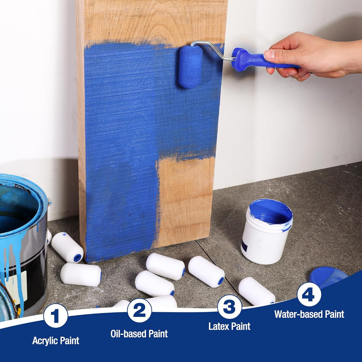 Mini foam paint roller cover applying blue paint to a narrow edge on wood panel.