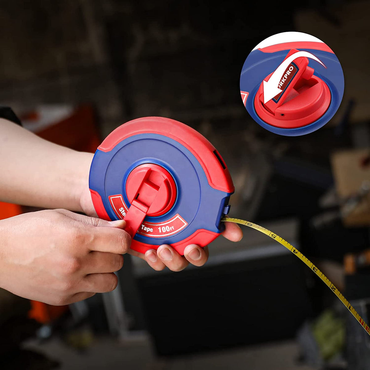 Hand holding red and blue closed reel tape measure with yellow tape extended